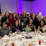 WI members around a table at Women Who Rock